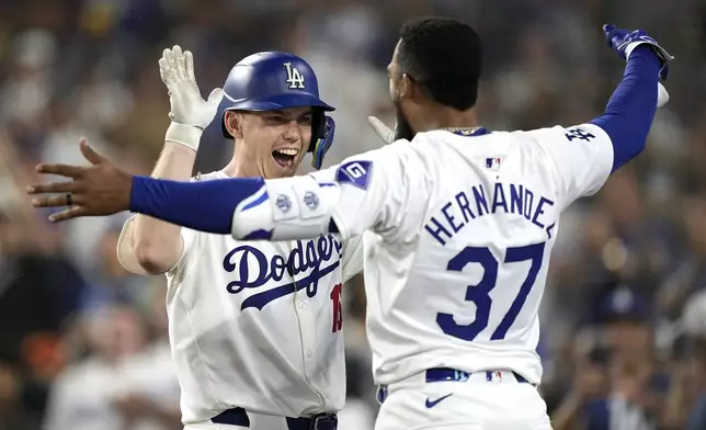 Los Angeles Dodgers' Will Smith, left, is congratulated by Teoscar Hernández after hitting a solo home run during the seventh inning of a baseball game against the Milwaukee Brewers Friday, July 5, 2024, in Los Angeles. (AP Photo/Mark J. Terrill)