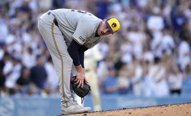 Milwaukee Brewers relief pitcher Bryan Hudson looks toward his dugout after giving up a solo home run to Los Angeles Dodgers' Miguel Vargas during the eighth inning of a baseball game Saturday, July 6, 2024, in Los Angeles. (AP Photo/Mark J. Terrill)