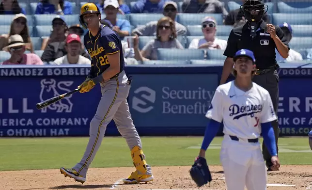 Milwaukee Brewers' Christian Yelich, left, heads to first for a two-run home run as Los Angeles Dodgers starting pitcher Justin Wrobleski watches during the fourth inning of a baseball game Sunday, July 7, 2024, in Los Angeles. (AP Photo/Mark J. Terrill)