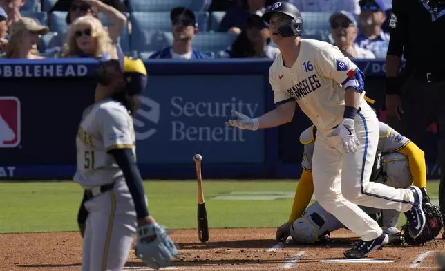 Los Angeles Dodgers' Will Smith, right, heads to first for a two-run home run as Milwaukee Brewers starting pitcher Freddy Peralta watches during the first inning of a baseball game Saturday, July 6, 2024, in Los Angeles. (AP Photo/Mark J. Terrill)