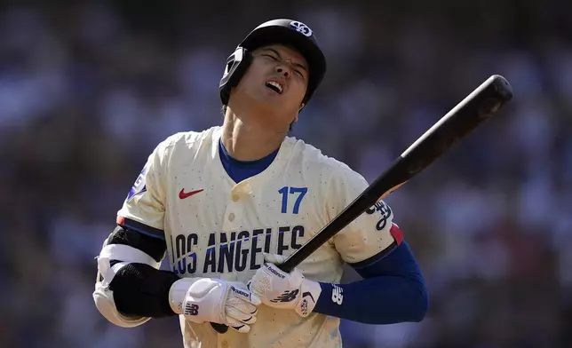 Los Angeles Dodgers' Shohei Ohtani reacts after being hit by a pitch during the second inning of a baseball game against the Milwaukee Brewers Saturday, July 6, 2024, in Los Angeles. (AP Photo/Mark J. Terrill)