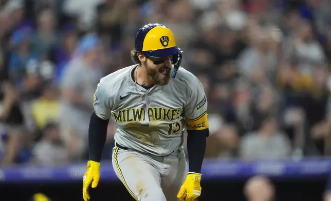 Milwaukee Brewers' Eric Haase reacts after diving in a run with a single off Colorado Rockies relief pitcher Justin Lawrence in the eighth inning of a baseball game Monday, July 1, 2024, in Denver. (AP Photo/David Zalubowski)