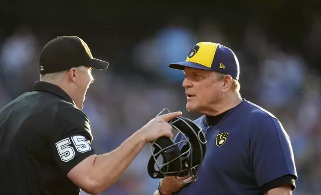 Milwaukee Brewers manager Pat Murphy, right, argues with umpire Brennan Miller, left, after Miller ejected him for arguing a call in the fifth inning of a baseball game against the Colorado Rockies, Monday, July 1, 2024, in Denver. (AP Photo/David Zalubowski)