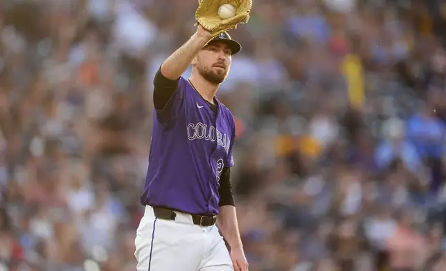 Colorado Rockies starting pitcher Austin Gomber calls for a new ball after giving up a slo home run to Milwaukee Brewers' William Contreras in the fifth inning of a baseball game Monday, July 1, 2024, in Denver. (AP Photo/David Zalubowski)