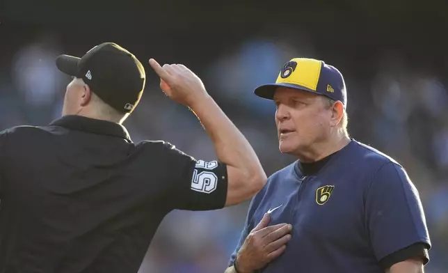 Home plate umpire Brennan Miller, left, ejects Milwaukee Brewers manager Pat Murphy, right, for arguing after Joey Ortiz was called out while legging out a ground ball hit to Colorado Rockies starting pitcher Austin Gomber in the fifth inning of a baseball game Monday, July 1, 2024, in Denver. (AP Photo/David Zalubowski)