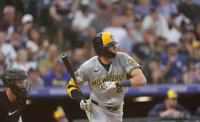 Milwaukee Brewers' Christian Yelich singles against Colorado Rockies starting pitcher Ryan Feltner in the fifth inning of a baseball game Tuesday, July 2, 2024, in Denver. (AP Photo/David Zalubowski)