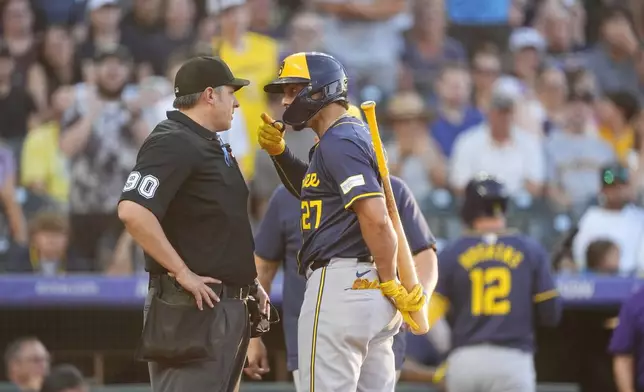 Milwaukee Brewers' Willy Adames, right, argues with home plate umpire Mark Ripperger after he ejected Adames for comments made after calling out Adames on strikes in the fifth inning of a baseball game against the Colorado Rockies Wednesday, July 3, 2024, in Denver. (AP Photo/David Zalubowski)