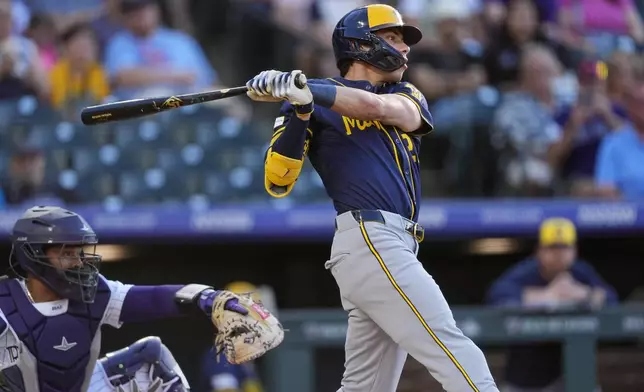 Milwaukee Brewers' Christian Yelich follows the flight of his solo home run off Colorado Rockies starting pitcher Dakota Hudson in the first inning of a baseball game, Wednesday, July 3, 2024, in Denver. (AP Photo/David Zalubowski)
