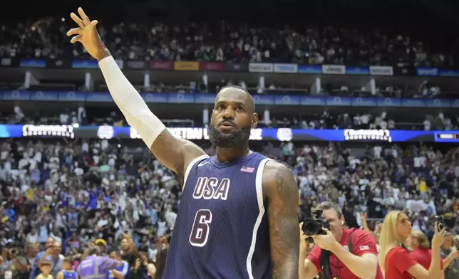 United States' forward LeBron James waves to the crowd after the end of an exhibition basketball game between the United States and South Sudan, at the o2 Arena in London, Saturday, July 20, 2024. (AP Photo/Kin Cheung)