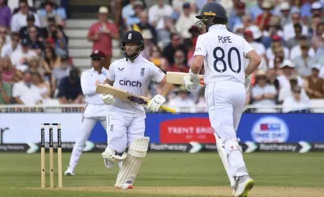 England's Ben Duckett, left, and England's Ollie Pope run between wickets during day three of the second Test between England and West Indies at Trent Bridge cricket ground, Nottingham, England, Saturday, July 20, 2024. (AP Photo/Rui Vieira)