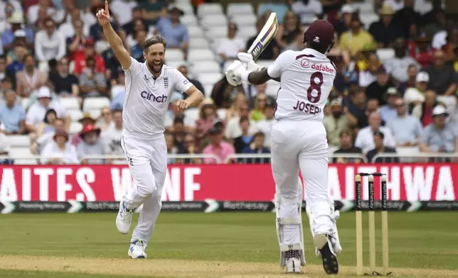 England's Chris Woakes, left, celebrates after dismissing West Indies Alzarri Joseph during day three of the second Test between England and West Indies at Trent Bridge cricket ground, Nottingham, England, Saturday, July 20, 2024. (AP Photo/Rui Vieira)