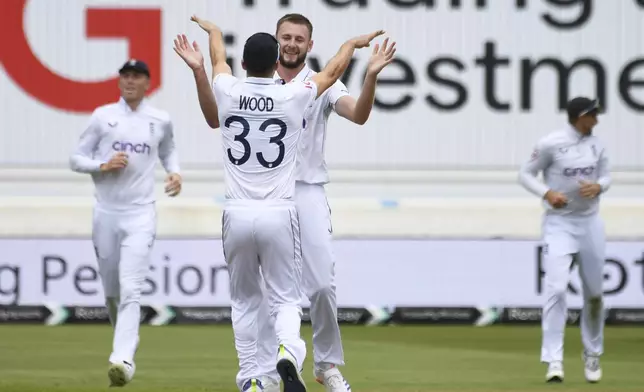 England's Gus Atkinson celebrates with England's Mark Wood (33) after dismissing West Indies Kevin Sinclair during day three of the second Test between England and West Indies at Trent Bridge cricket ground, Nottingham, England, Saturday, July 20, 2024. (AP Photo/Rui Vieira)