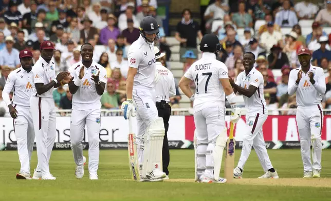 West Indies players celebrate after England's Zak Crawley, centre left, is run out during day three of the second Test between England and West Indies at Trent Bridge cricket ground, Nottingham, England, Saturday, July 20, 2024. (AP Photo/Rui Vieira)