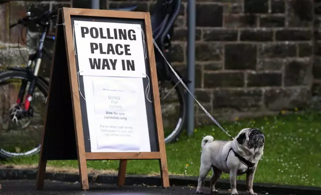 A dog waits outside Pollokshields Burgh Halls polling station during the 2024 General Election, in Glasgow, Scotland, Thursday July 4, 2024. (Andrew Milligan/PA via AP)