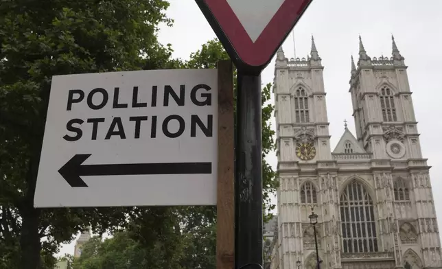 A polling station sign points to where local residents can cast their votes ahead of the general election, in London, Wednesday, July 3, 2024. (AP Photo/Kin Cheung)