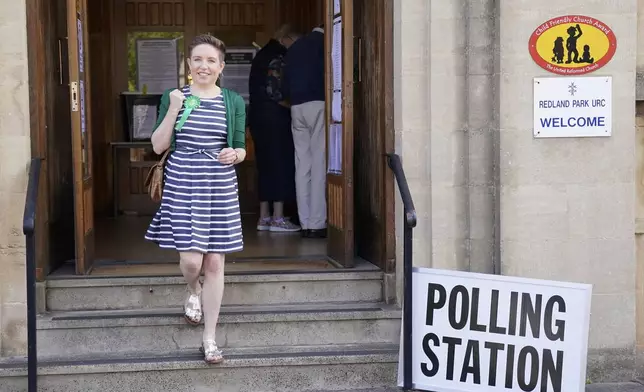 Green Party co-leader Carla Denyer walks out of a polling booth after casting her vote in the 2024 General Election at Redland Park United Reformed Church in Bristol, England, Thursday, July 4, 2024. (Jonathan Brady/PA via AP)