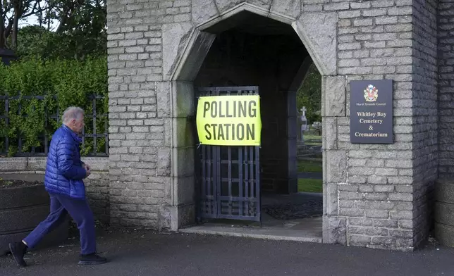 A voter arrives to cast his ballot at a 2024 General Election polling station in Whitley Bay Cemetery and Crematorium, in north east England, Thursday July 4, 2024. (Owen Humphreys/PA via AP)