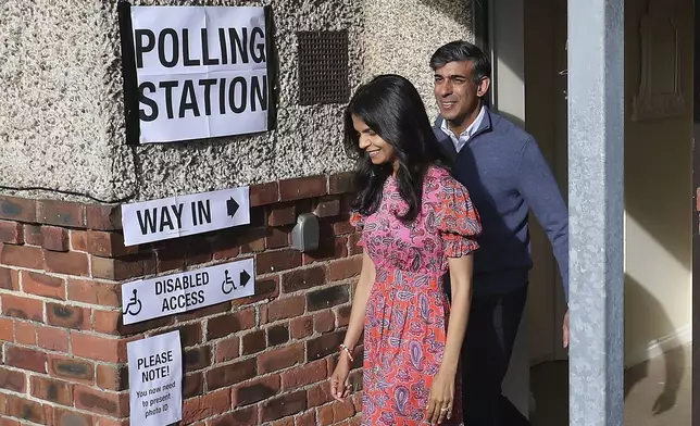 Britain's Prime Minister Rishi Sunak and his wife Akshata Murty leave a polling station after voting near Richmond, North Yorkshire, England, Thursday, July 4, 2024. Britain goes to the polls Thursday after Prime Minister Rishi Sunak called a general election. (AP Photo/Scott Heppell )