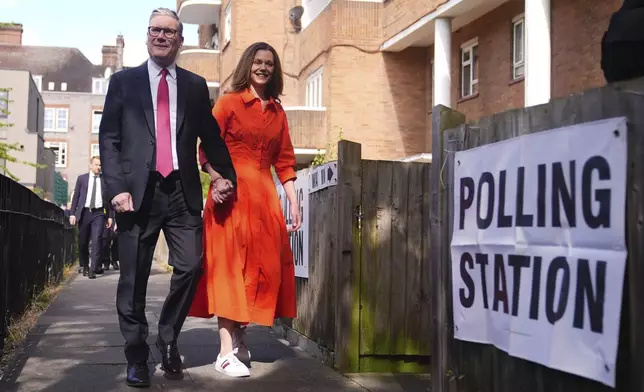 Labour leader Keir Starmer and his wife Victoria arrive to cast their votes in the 2024 General Election at Willingham Close TRA Hall in London, Thursday July 4, 2024. (James Manning/PA via AP)