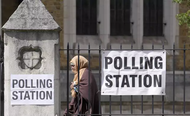 A woman leaves after casting her vote at a polling station in London, Thursday, July 4, 2024. Voters in the U.K. are casting their ballots in a national election to choose the 650 lawmakers who will sit in Parliament for the next five years. Outgoing Prime Minister Rishi Sunak surprised his own party on May 22 when he called the election. (AP Photo/Vadim Ghirda)
