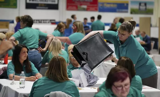 Ballot boxes are emptied at Ice Hall in the Dewars Centre, Perth, Scotland, during the count for the Perth and North Perthshire constituency in the 2024 General Election, Thursday, July 4, 2024. Britain’s Labour Party was headed for a huge majority in Britain’s election on Thursday, an exit poll suggested. (Jane Barlow/PA via AP)