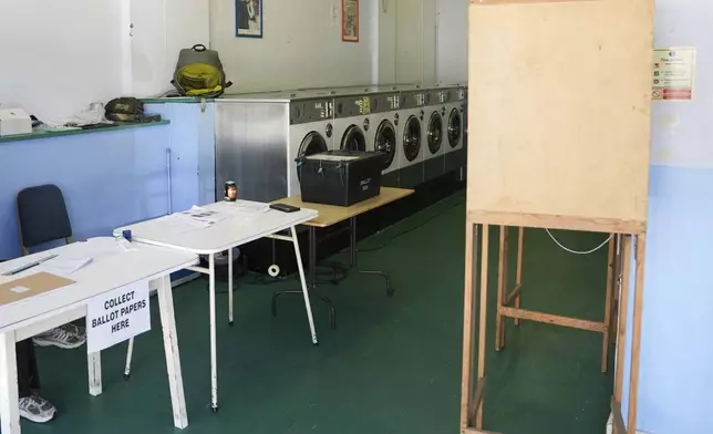 A polling station is installed inside a launderette for the 2024 General Election, in Oxford, England, Thursday July 4, 2024. (Jacob King/PA via AP)
