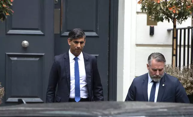 Outgoing British Prime Minister Rishi Sunak, left, leaves the Conservative Campaign Headquarters in London, Friday, July 5, 2024. Britain's Labour Party swept to power Friday after more than a decade in opposition, as a jaded electorate handed the party a landslide victory, but also a mammoth task of reinvigorating a stagnant economy and dispirited nation. (AP Photo/Thomas Krych)