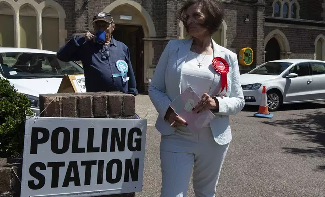 Anne-Marie Laffey from the Labour Party waits at a polling station in Clacton On Sea, England, Thursday, July 4, 2024. Voters in the U.K. are casting their ballots in a national election to choose the 650 lawmakers who will sit in Parliament for the next five years. Outgoing Prime Minister Rishi Sunak surprised his own party on May 22 when he called the election. (AP Photo/Thomas Krych)