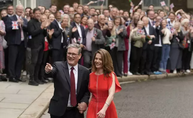 Britain's Labour Party Prime Minister Keir Starmer and his wife Victoria arrive in Downing Street and greet supporters in London, Friday, July 5, 2024. Labour leader Stammer won the general election on July 4, and was appointed Prime Minster by King Charles III at Buckingham Palace, after the party won a landslide victory. (AP Photo/Vadim Ghirda)