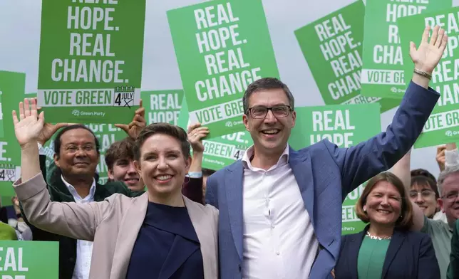 FILE - Green Party co-leaders Adrian Ramsay, right, and Carla Denyer pose with supporters at their General Election Manifesto launch in Hove, England, on June 12, 2024. (AP Photo/Kirsty Wigglesworth, File)