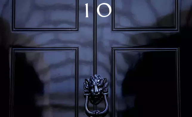 FILE - The door to 10 Downing Street in London, Friday, July 8, 2022. The United Kingdom will hold its first national election in almost five years on Thursday, with opinion polls suggesting that Prime Minister Rishi Sunak’s Conservative Party will be punished for failing to deliver on promises made during 14 years in power. (AP Photo/Frank Augstein, File)