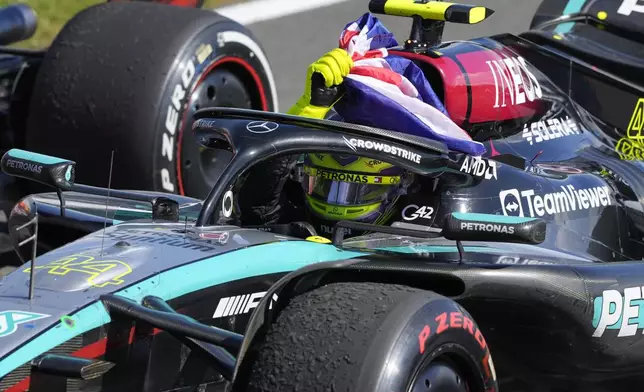 Mercedes driver Lewis Hamilton of Britain celebrates after winning the British Formula One Grand Prix race at the Silverstone racetrack, Silverstone, England, Sunday, July 7, 2024. (AP Photo/Luca Bruno)