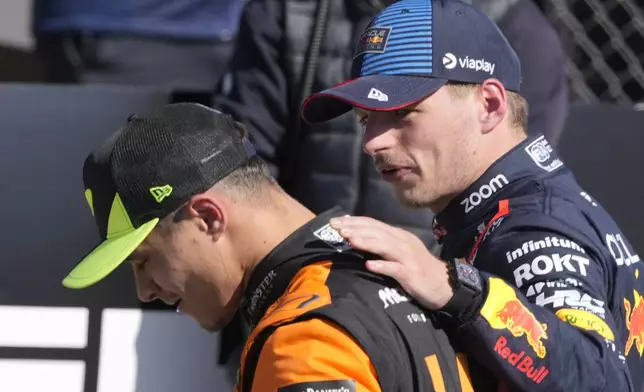 Red Bull driver Max Verstappen of the Netherlands, right, hugs McLaren driver Lando Norris of Britain after the British Formula One Grand Prix race at the Silverstone racetrack, Silverstone, England, Sunday, July 7, 2024. (AP Photo/Luca Bruno)