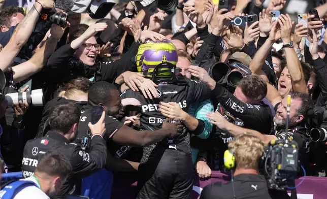 Mercedes driver Lewis Hamilton of Britain celebrates after winning the British Formula One Grand Prix race at the Silverstone racetrack, Silverstone, England, Sunday, July 7, 2024. (AP Photo/Luca Bruno)