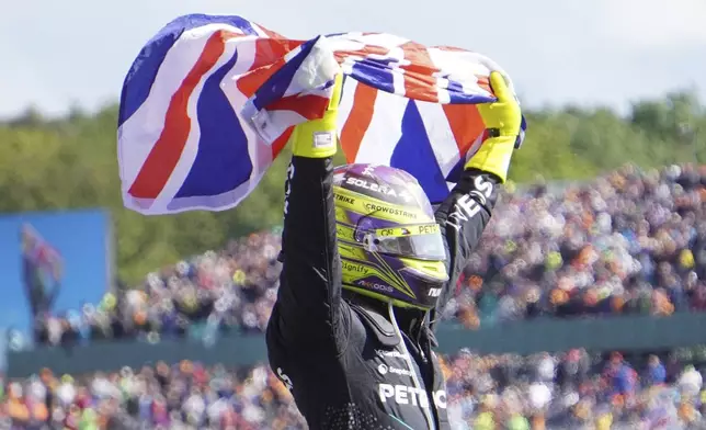 Mercedes driver Lewis Hamilton of Britain celebrates after winning the British Formula One Grand Prix race at the Silverstone racetrack, Silverstone, England, Sunday, July 7, 2024. (Matthew Vincent/PA via AP)