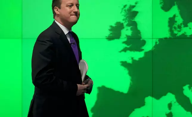 FILE - Britain's Prime Minister David Cameron walks past a map of Europe on a screen as he walks away after making a speech on holding a referendum on staying in the European Union in London, Jan. 23, 2013. The U.K. election in December 2019 was basically about one issue: Brexit. General elections in the U.K. are typically held in the spring or early summer. But in the fall of 2019, the recently-appointed Prime Minister Boris Johnson gambled on holding one on December 12, when most people just want to get ready for Christmas and would rather think of anything but politics. (AP Photo/Matt Dunham, File)