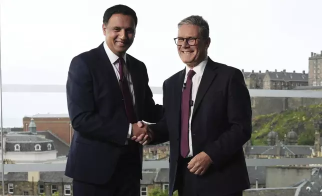 British Prime Minister Sir Keir Starmer, right, and Scottish Labour Leader Anas Sarwar during an event in Edinburgh to welcome new Labour MPs in Scotland, following Labour's victory in the 2024 General Election, Sunday July 7, 2024. (Andrew Milligan/PA via AP)