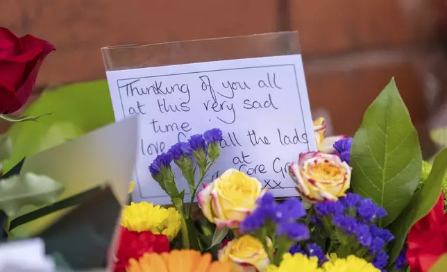 Floral tributes near the scene in Hart Street, Southport, Britain, Tuesday July 30, 2024, where two children died and nine were injured in a "ferocious" knife attack during a Taylor Swift event at a dance school on Monday. A 17-year-old male from Banks, Lancashire, has been arrested on suspicion of murder and attempted murder over the incident. (James Speakman/PA via AP)