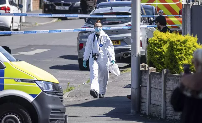 A police scenes of crime officer (SOCO) works at the scene in Southport, Merseyside, where a man has been detained and a knife has been seized after a number of people were injured in a reported stabbing, Monday July 29, 2024. (James Speakman/PA via AP)