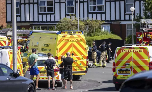 Police and emergency services arrive at the site where a man has been detained and a knife has been seized after a number of people were injured in a reported stabbing, in Southport, Merseyside, England, Monday July 29, 2024. (James Speakman/PA via AP)