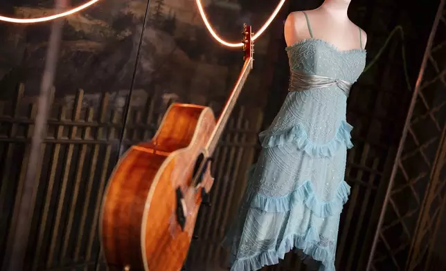 A guitar and stage costume from previous concert tours are displayed at the 'Taylor Swift Songbook Trail Exhibition' at the Victoria &amp; Albert Museum, on Wednesday, July 24, 2024 in London. (Photo by Scott A Garfitt/Invision/AP)