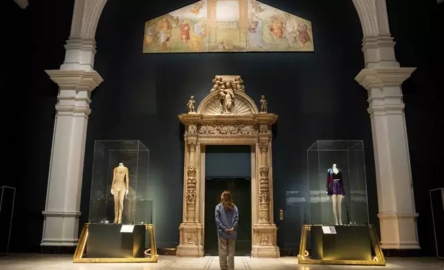 A member of staff views stage costumes from previous concert tours that are displayed at the 'Taylor Swift Songbook Trail Exhibition' in the Raphael Gallery at the Victoria &amp; Albert Museum, on Wednesday, July 24, 2024 in London. (Photo by Scott A Garfitt/Invision/AP)