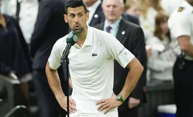 Novak Djokovic of Serbia reacts as he is interviewed after defeating Holger Rune of Denmark in their fourth round match at the Wimbledon tennis championships in London, Monday, July 8, 2024. (AP Photo/Mosa'ab Elshamy)