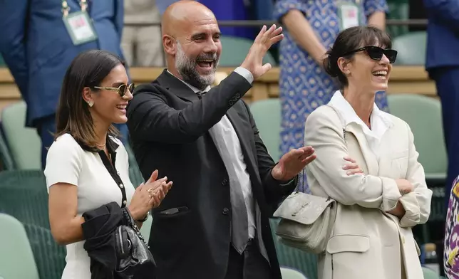 Pep Guardiola his wife Cristina and daughter Maria, left, react as Alexander Zverev of Germany speaks following his third round win over Cameron Norrie of Britain at the Wimbledon tennis championships in London, Saturday, July 6, 2024. (AP Photo/Kirsty Wigglesworth)