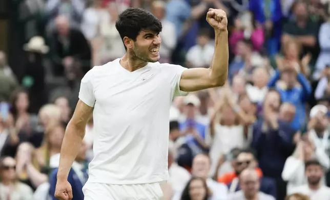 Carlos Alcaraz of Spain celebrates after defeating Tommy Paul of the United States in their quarterfinal match at the Wimbledon tennis championships in London, Tuesday, July 9, 2024. (AP Photo/Kirsty Wigglesworth)