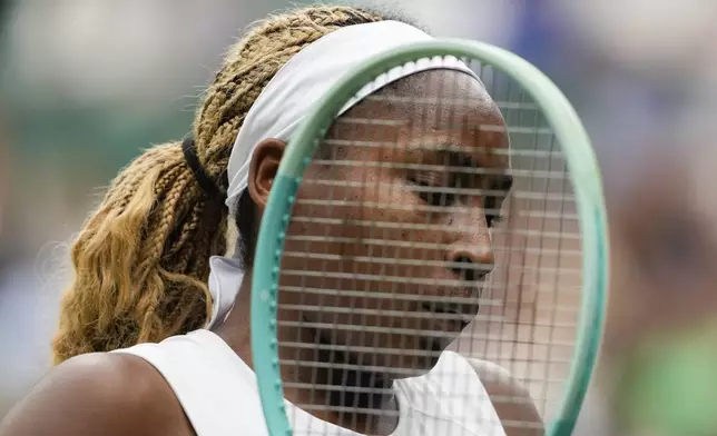 Coco Gauff of the United States plays a prepares to serve to Anca Todoni of Romania during their match on day three at the Wimbledon tennis championships in London, Wednesday, July 3, 2024. (AP Photo/Mosa'ab Elshamy)