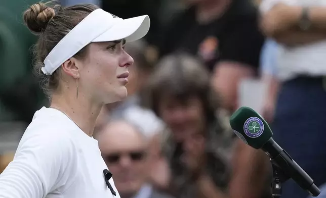 Elina Svitolina of Ukraine addresses the crowd defeating Xinyu Wang of China in their fourth round match at the Wimbledon tennis championships in London, Monday, July 8, 2024. (AP Photo/Mosa'ab Elshamy)