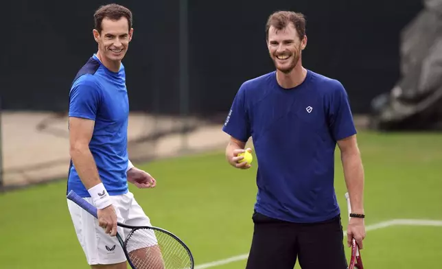 Andy Murray, left, and Jamie Murray stand on the practise courts on day two of the 2024 Wimbledon Championships at the All England Lawn Tennis and Croquet Club, London, Tuesday July 2, 2024. (Jordan Pettitt/PA via AP)
