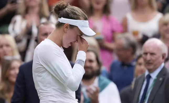 Barbora Krejcikova of the Czech Republic reacts after defeating Elena Rybakina of Kazakhstan in their semifinal match at the Wimbledon tennis championships in London, Thursday, July 11, 2024. (AP Photo/Alberto Pezzali)