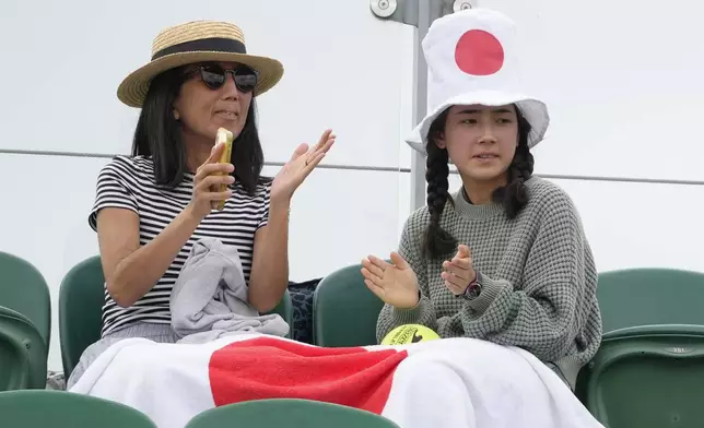 Spectactors watch the Naomi Osaka of Japan and Diane Parry of France during their first round match of the Wimbledon tennis championships in London, Monday, July 1, 2024. (AP Photo/Kirsty Wigglesworth)